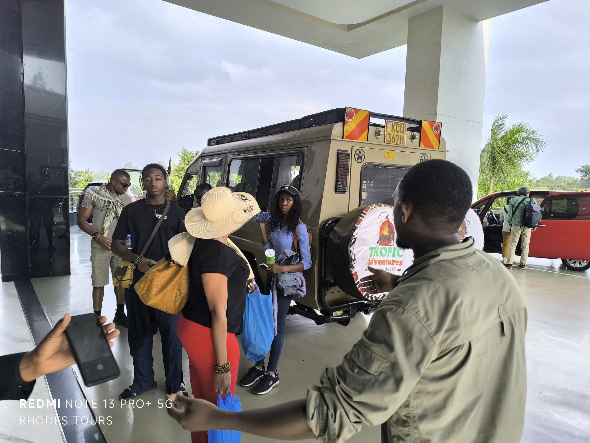 Guests being welcomed around a safari vehicle